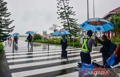 arsip-foto-seorang-petugas-kanan-memberikan-payung-kepada-4k-hbt0.jpg